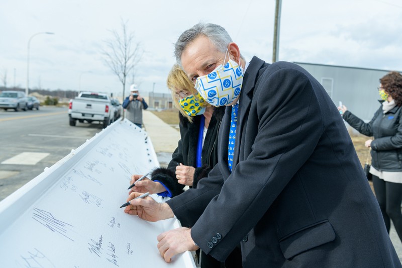 University of Delaware President Dennis Assanis and his wife, Eleni, were among those who signed the final beam of the FinTech Innovation Hub.